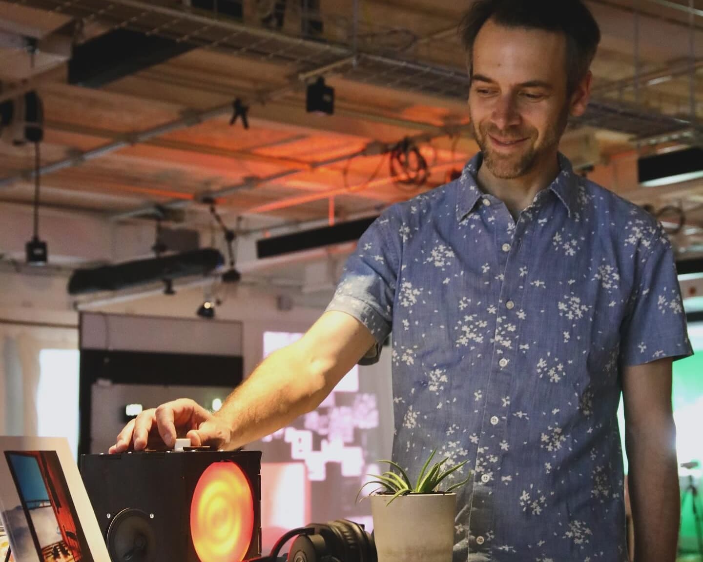 Jesse Fischer standing in front of a colorful art installation.